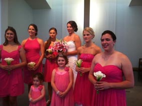 Bride with five bridesmaids in red and flower girl
